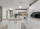 Modern kitchen with white cabinets, granite island, and tile backsplash at 1009 Cobblestone Dr, Spring Hill, FL 34606