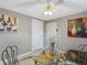 Bright dining room with glass table and four chairs, offering a view of the kitchen at 1009 Cobblestone Dr, Spring Hill, FL 34606
