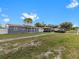 Newly renovated home with a gray exterior and solar panels at 1009 Cobblestone Dr, Spring Hill, FL 34606