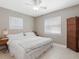 Spacious bedroom with king-size bed, window blinds, and a decorative room divider at 1009 Cobblestone Dr, Spring Hill, FL 34606