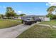 Newly renovated home with a gray exterior and solar panels at 1009 Cobblestone Dr, Spring Hill, FL 34606