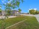 Spacious backyard with grassy area, white vinyl fence, and a patio at 1009 Cobblestone Dr, Spring Hill, FL 34606