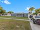 Newly renovated home with gray exterior and a burgundy door at 1009 Cobblestone Dr, Spring Hill, FL 34606