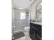 Modern bathroom with walk-in shower, toilet, and dark vanity at 1009 Cobblestone Dr, Spring Hill, FL 34606