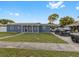 Newly renovated home with a gray exterior and solar panels at 1009 Cobblestone Dr, Spring Hill, FL 34606