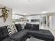 Open concept living room with sectional sofa and kitchen view at 1009 Cobblestone Dr, Spring Hill, FL 34606