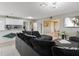 Open living room and kitchen with sectional sofa and large TV at 1009 Cobblestone Dr, Spring Hill, FL 34606