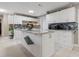 Modern kitchen with white cabinets, granite island, and tile backsplash at 1009 Cobblestone Dr, Spring Hill, FL 34606