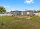 Backyard with grassy area, partially fenced, and some landscaping at 1009 Cobblestone Dr, Spring Hill, FL 34606