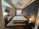 Modern bedroom with king-size bed, dark accent wall, and wooden nightstands at 100 4Th S Ave # 205, St Petersburg, FL 33701