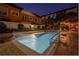 Night view of the community pool with surrounding buildings and landscaping at 100 4Th S Ave # 205, St Petersburg, FL 33701