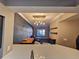View of the living room from the kitchen with modern light fixtures and open shelving at 100 4Th S Ave # 205, St Petersburg, FL 33701