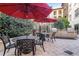 Outdoor patio area with tables, chairs, red umbrellas, and a grilling station at 100 4Th S Ave # 205, St Petersburg, FL 33701