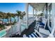 Relaxing balcony overlooking waterfront with rocking chairs at 10045 Gulf Blvd, Treasure Island, FL 33706