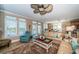 Spacious living room with leather sofas, a large TV, and access to a balcony at 10045 Gulf Blvd, Treasure Island, FL 33706