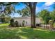 Side view of house with mature trees and lawn at 13751 13Th St, Dade City, FL 33525