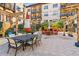 Community patio with table and chairs under umbrellas at 100 4Th S Ave # 205, St Petersburg, FL 33701