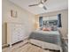 Spacious bedroom with a comfortable bed, dresser, and ceiling fan at 4611 W Fig St # 209, Tampa, FL 33609