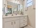 Updated bathroom with a vanity, mirror, and gold accents at 4611 W Fig St # 209, Tampa, FL 33609