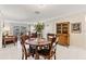 Dining area with a round table and four chairs, next to living room at 4611 W Fig St # 209, Tampa, FL 33609