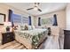 Main bedroom with king-size bed, ample natural light, and ceiling fan at 4611 W Fig St # 209, Tampa, FL 33609