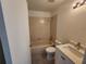 Clean bathroom with beige tile, a tub, toilet and a white vanity at 13625 Laraway Dr, Riverview, FL 33579