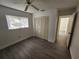 Bright bedroom with neutral walls, wood-look flooring and a double door closet at 13625 Laraway Dr, Riverview, FL 33579