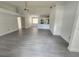 Bright living room with gray vinyl flooring and open kitchen at 13625 Laraway Dr, Riverview, FL 33579