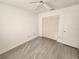 Well-lit bedroom featuring neutral walls, wood-look flooring, and a double-door closet at 13625 Laraway Dr, Riverview, FL 33579