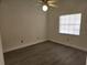 Bright bedroom with neutral walls, wood-look flooring and a window with blinds at 13625 Laraway Dr, Riverview, FL 33579
