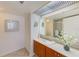 Clean bathroom with wood vanity, double sinks, and a shower/tub combo at 220 Belleview Blvd # 802, Belleair, FL 33756