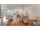 Bright dining area with hardwood floors and glass table, easily fits four chairs at 220 Belleview Blvd # 802, Belleair, FL 33756