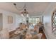Bright dining area with glass table and wicker chairs, adjacent to living room at 220 Belleview Blvd # 802, Belleair, FL 33756