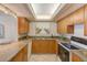 Well-equipped kitchen with wood cabinets, granite countertops and a gas cooktop at 220 Belleview Blvd # 802, Belleair, FL 33756