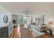 Living room features hardwood floors, neutral decor, and access to balcony at 220 Belleview Blvd # 802, Belleair, FL 33756