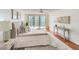 Main bedroom with hardwood floors, king bed, and access to private balcony at 220 Belleview Blvd # 802, Belleair, FL 33756
