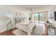 Main bedroom with hardwood floors, neutral decor and access to a balcony at 220 Belleview Blvd # 802, Belleair, FL 33756