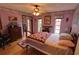 Charming bedroom with hardwood floors, ceiling fan, closet, and natural light offers a cozy retreat at 7906 Willow Brook Ct, Hudson, FL 34667