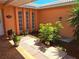 Private courtyard featuring brick flooring, landscaping, and a hanging bird feeder offers a serene outdoor space at 7906 Willow Brook Ct, Hudson, FL 34667