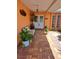 Inviting front porch featuring brick flooring, plants, bench, and a double-door entry welcomes you home at 7906 Willow Brook Ct, Hudson, FL 34667