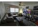 Cozy living room with plush seating, ceiling fan, and a large TV with entertainment center at 7906 Willow Brook Ct, Hudson, FL 34667