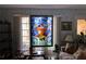 Unique living room features custom stained glass decor, plush seating and ample natural light creating a unique ambiance at 7906 Willow Brook Ct, Hudson, FL 34667