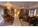 Spacious living room featuring tile floors, dining area, chandelier, and comfortable seating at 7906 Willow Brook Ct, Hudson, FL 34667