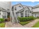 Exterior view of the condo building with a staircase and landscaping at 12267 Armenia Gables Cir # 12267, Tampa, FL 33612