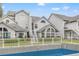 Community pool with a view of the building exterior and surrounding fence at 12267 Armenia Gables Cir # 12267, Tampa, FL 33612