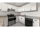 Modern kitchen with white cabinets, stainless steel appliances, and granite countertops at 12267 Armenia Gables Cir # 12267, Tampa, FL 33612