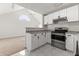 Updated kitchen with white cabinets, stainless steel appliances, and granite countertops at 12267 Armenia Gables Cir # 12267, Tampa, FL 33612