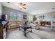 Spacious living room with light beige sofas and a large TV at 11537 Southern Creek Dr, Gibsonton, FL 33534