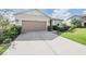 One-story house with a two-car garage and well-manicured lawn at 11537 Southern Creek Dr, Gibsonton, FL 33534
