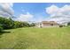 Spacious backyard featuring a grassy area and home exterior at 11537 Southern Creek Dr, Gibsonton, FL 33534